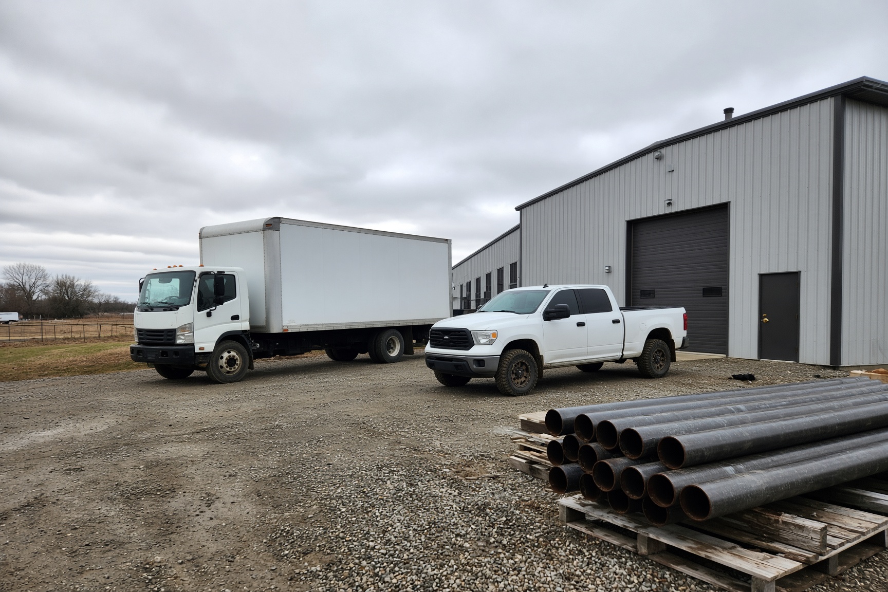Unmarked work trucks and equipment at a Midwestern job site