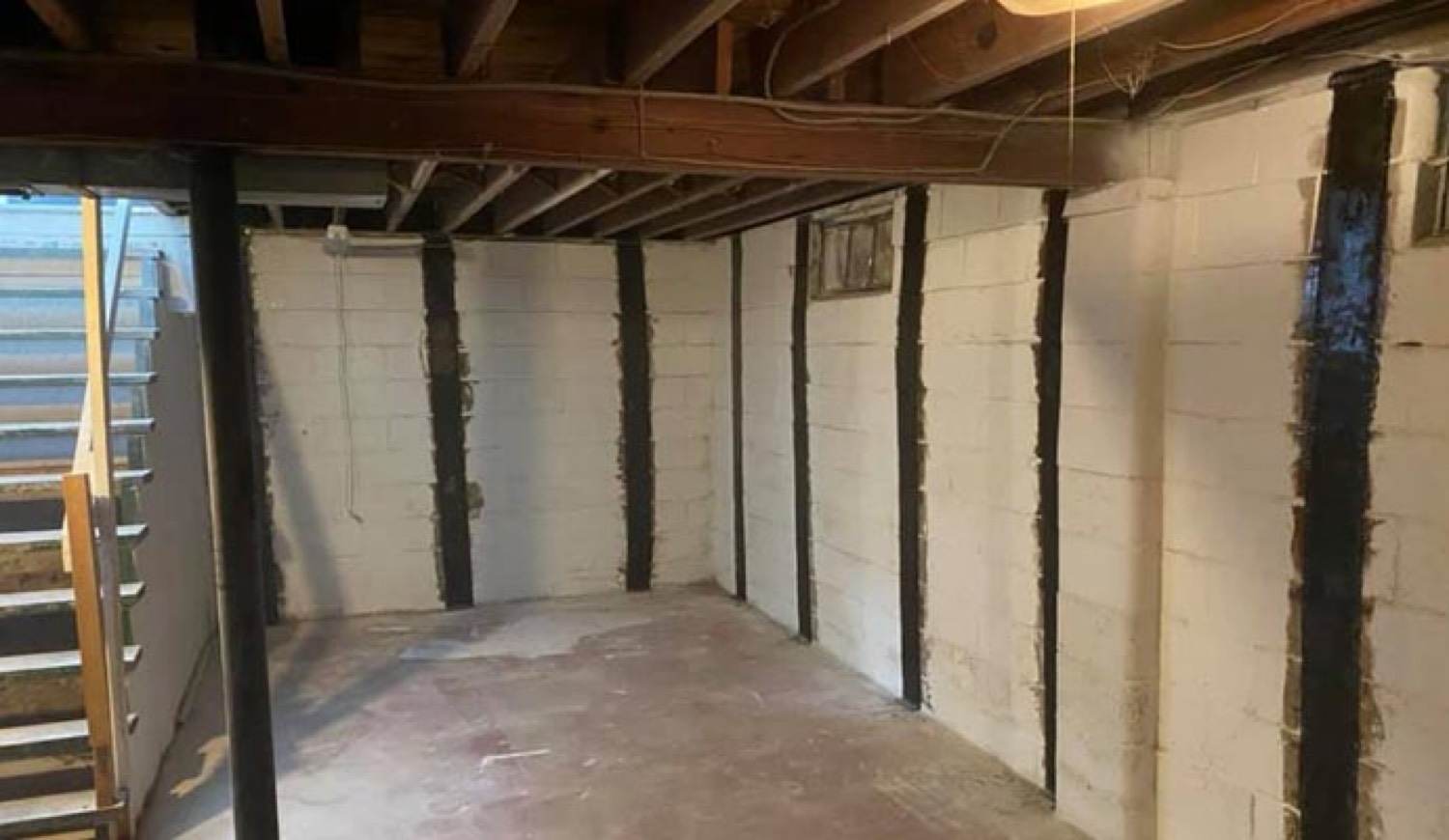 Carbon fiber straps on painted block basement walls